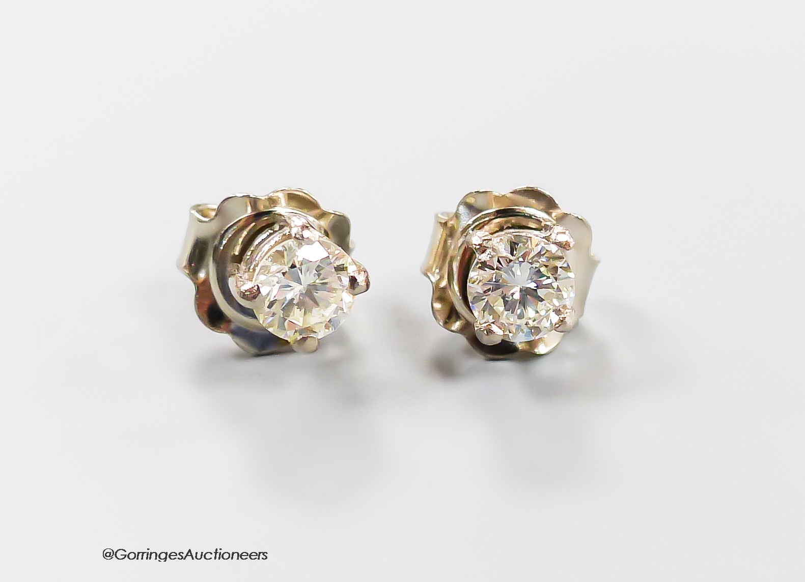 A modern pair of 750 white metal and solitaire diamond ear studs, each stone weighing approximately 0.23ct, gross weight 1.3 grams.